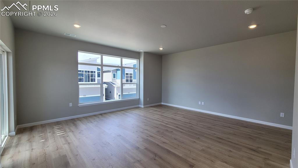 Image 20 of 39: Living room with LVP flooring, LED Lighting, Walk-Out to Deck-Incredible Vi