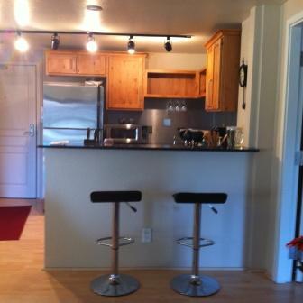 Image 2 of 13: Living area featuring wood-finish flooring, a full wall of glass with balco