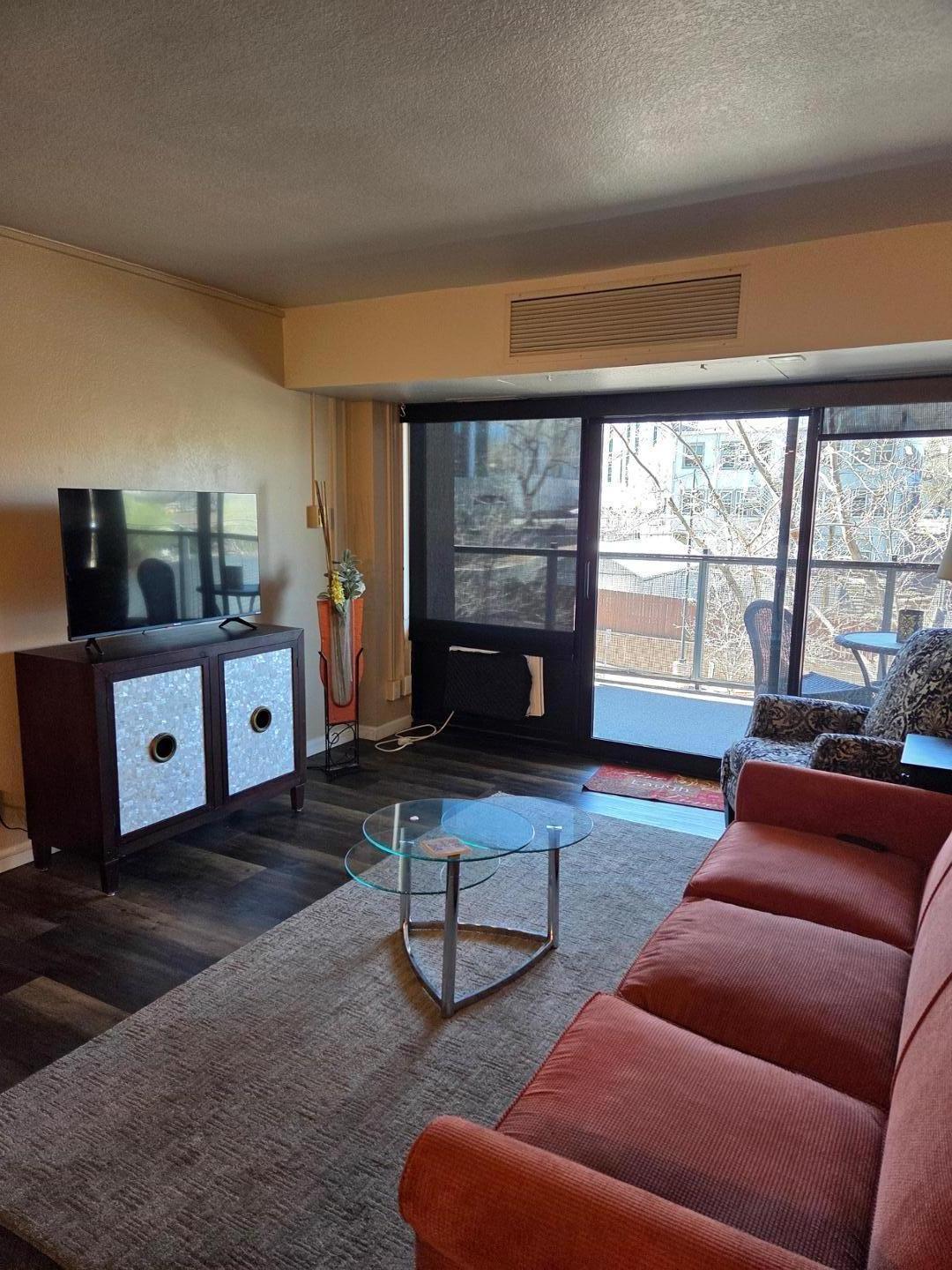 Image 7 of 13: Wood-finish flooring with baseboards and walk out to balcony