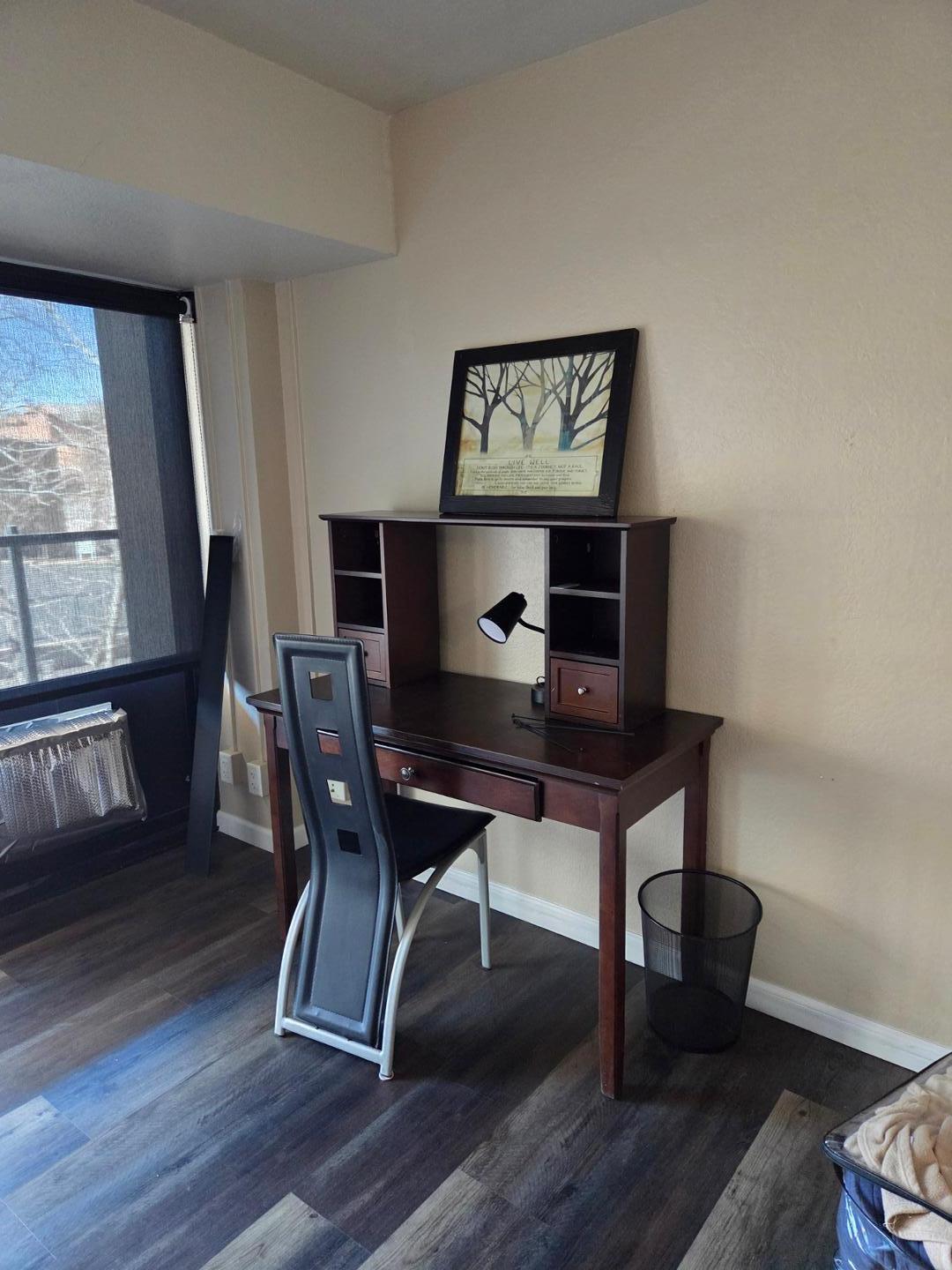 Image 8 of 13: per large Bedroom featuring wood-finish flooring, a light-colored wall fini